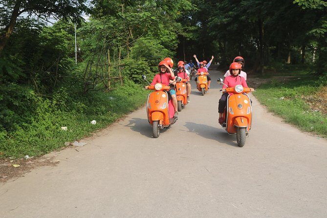 Hanoi Vespa Full Day City & Countryside with Female Ao Dai Riders - West Lake and Huu Hiep Lake: botanical paths and a heavy historical stop